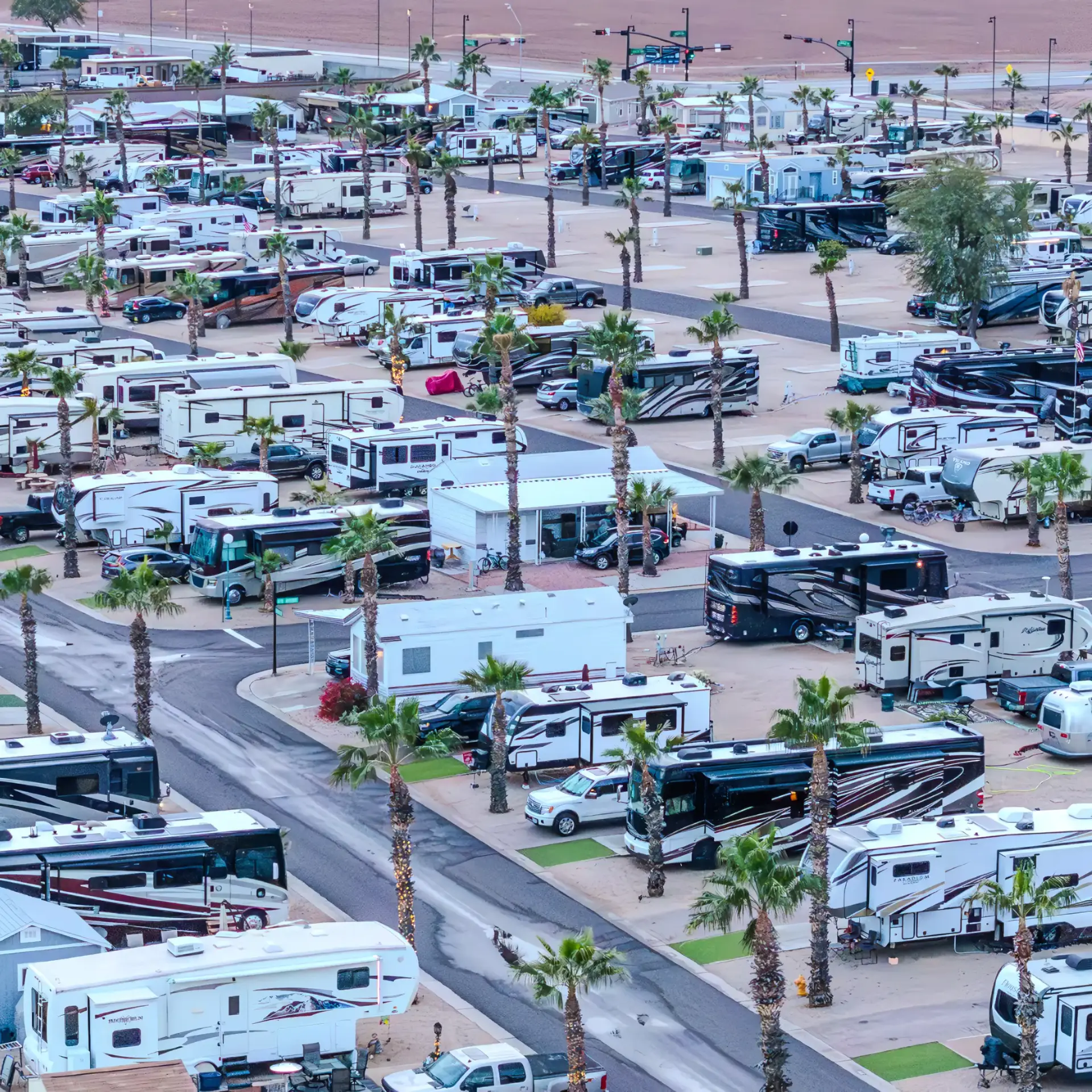 Early booking offers benefits for Arizona winter visitors, including prime spots among the palm trees and numerous recreational vehicles visible from an aerial view of the expansive RV park.