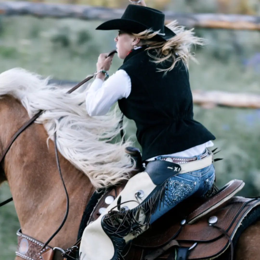 With wind sweeping through their hair, a person in a cowboy hat dashes across the open landscape of Durango, horseback riding at full speed for an exhilarating taste of outdoor fun.